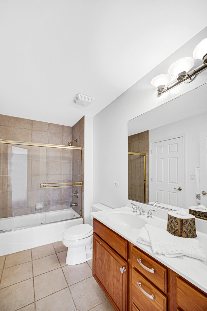 726 St Johns Place Addison, IL 60101 - Photo 25 of 39 a spacious bathroom with a granite countertop sink a toilet and shower