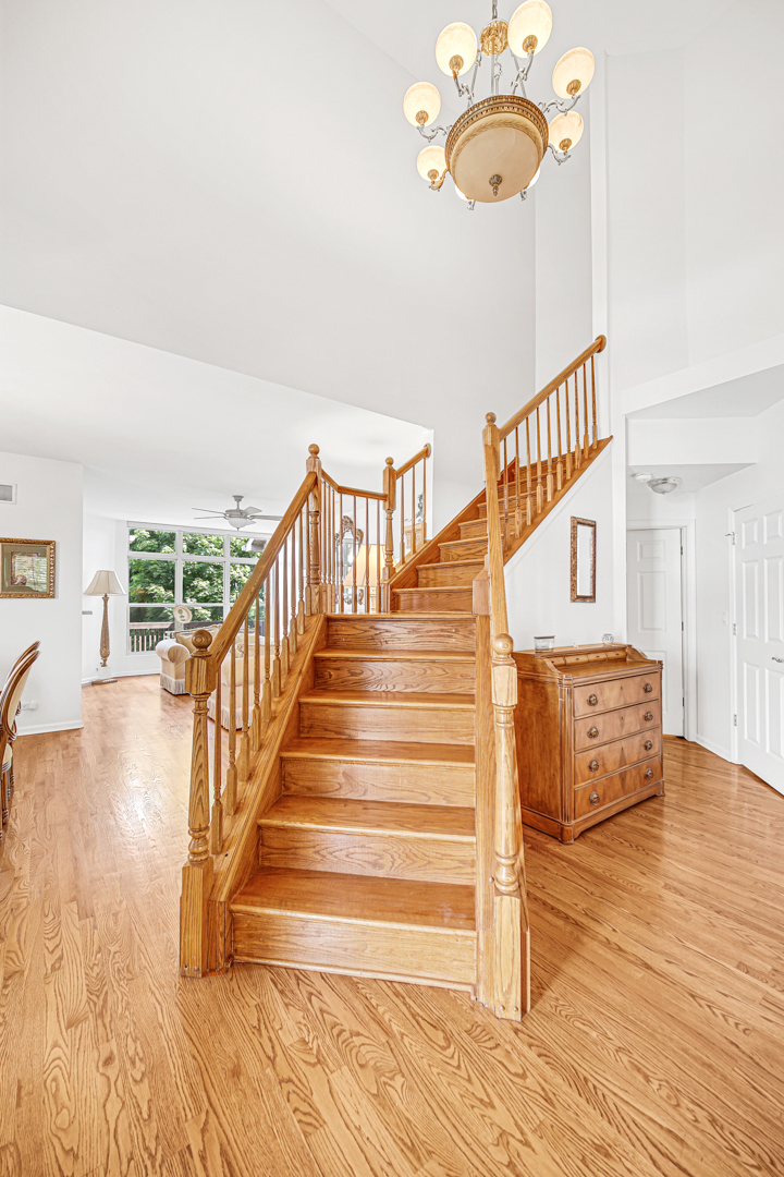 726 St Johns Place Addison, IL 60101 - Photo 5 of 39 a view of staircase with a large window and wooden floor