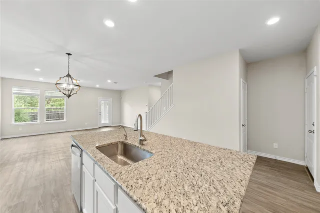 a kitchen with a sink cabinets and window