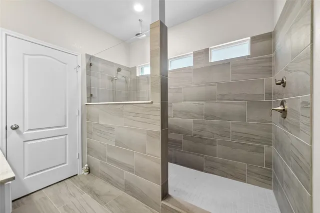 a bathroom with a glass shower door