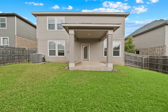 a view of a house with a backyard