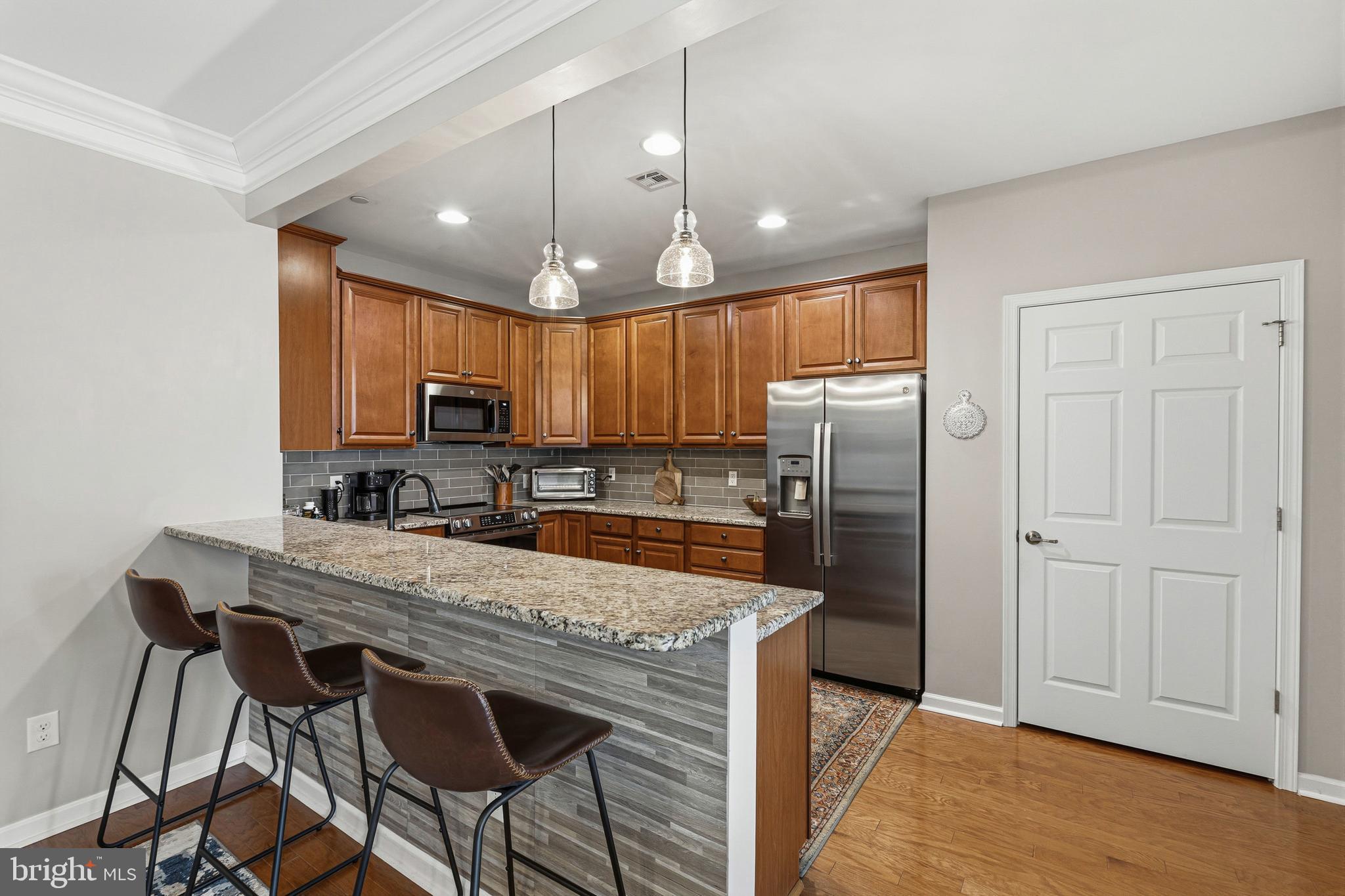 5217 Poplar Street Garnet Valley, PA 19060 - Photo 17 of 32 a kitchen with refrigerator cabinets and wooden floor