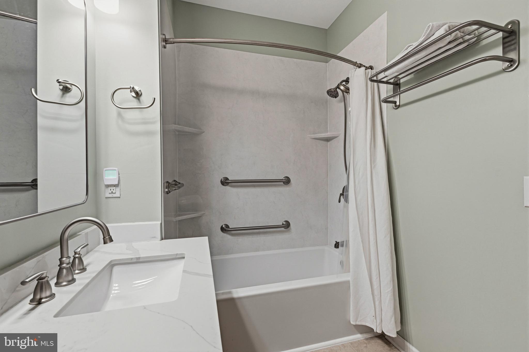 5217 Poplar Street Garnet Valley, PA 19060 - Photo 24 of 32 a bathroom with a tub shower sink and vanity