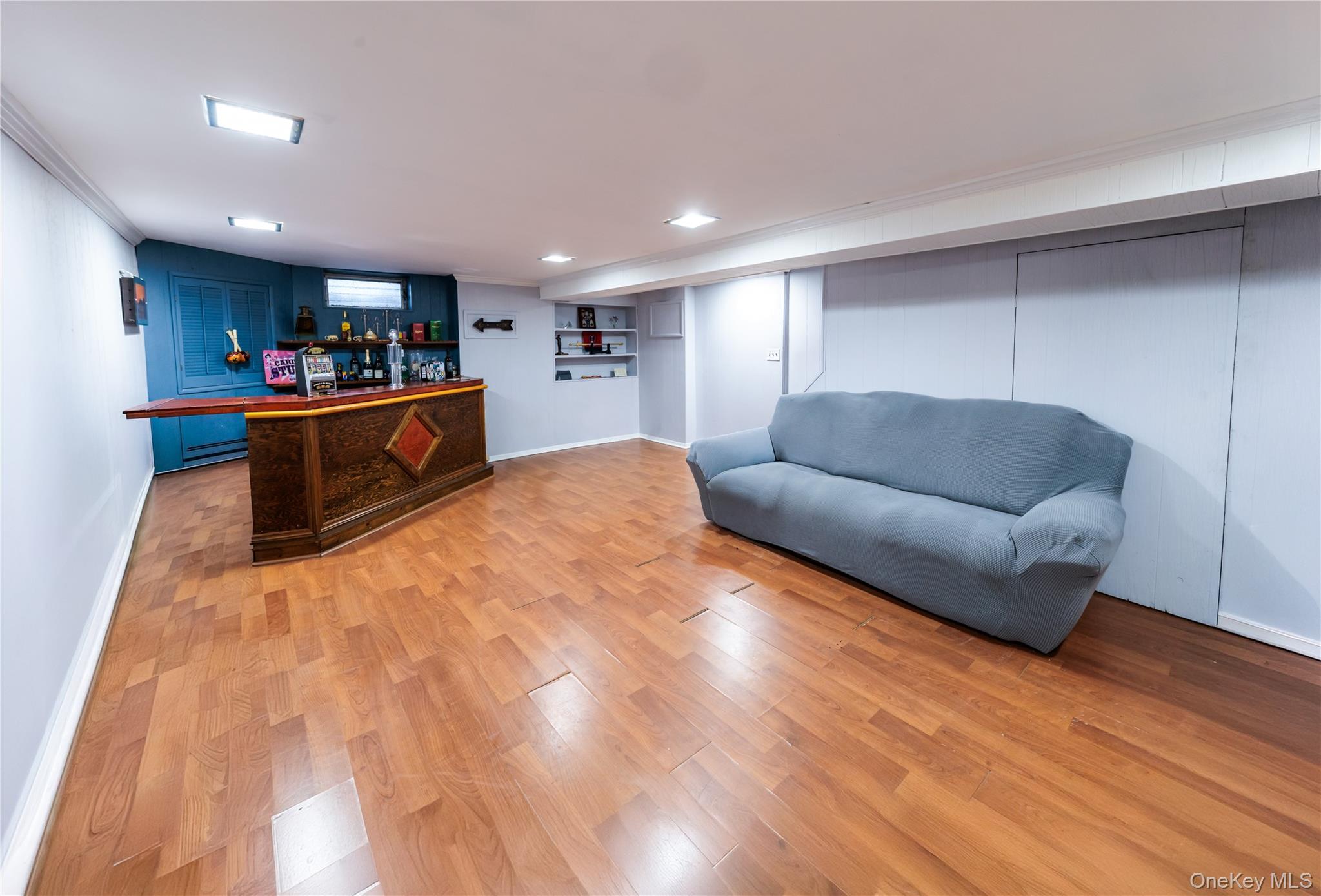 678 Front Street, Unit E Hempstead, NY 11550 - Photo 11 of 22 a living room with furniture and a wooden floor