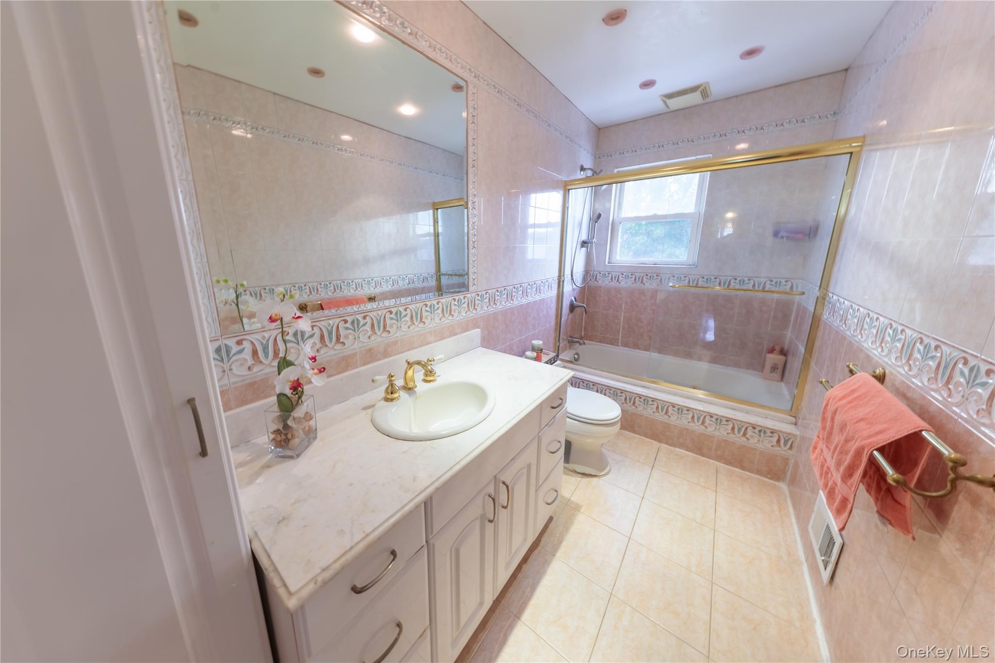 678 Front Street, Unit E Hempstead, NY 11550 - Photo 18 of 22 a bathroom with a double vanity sink and a mirror