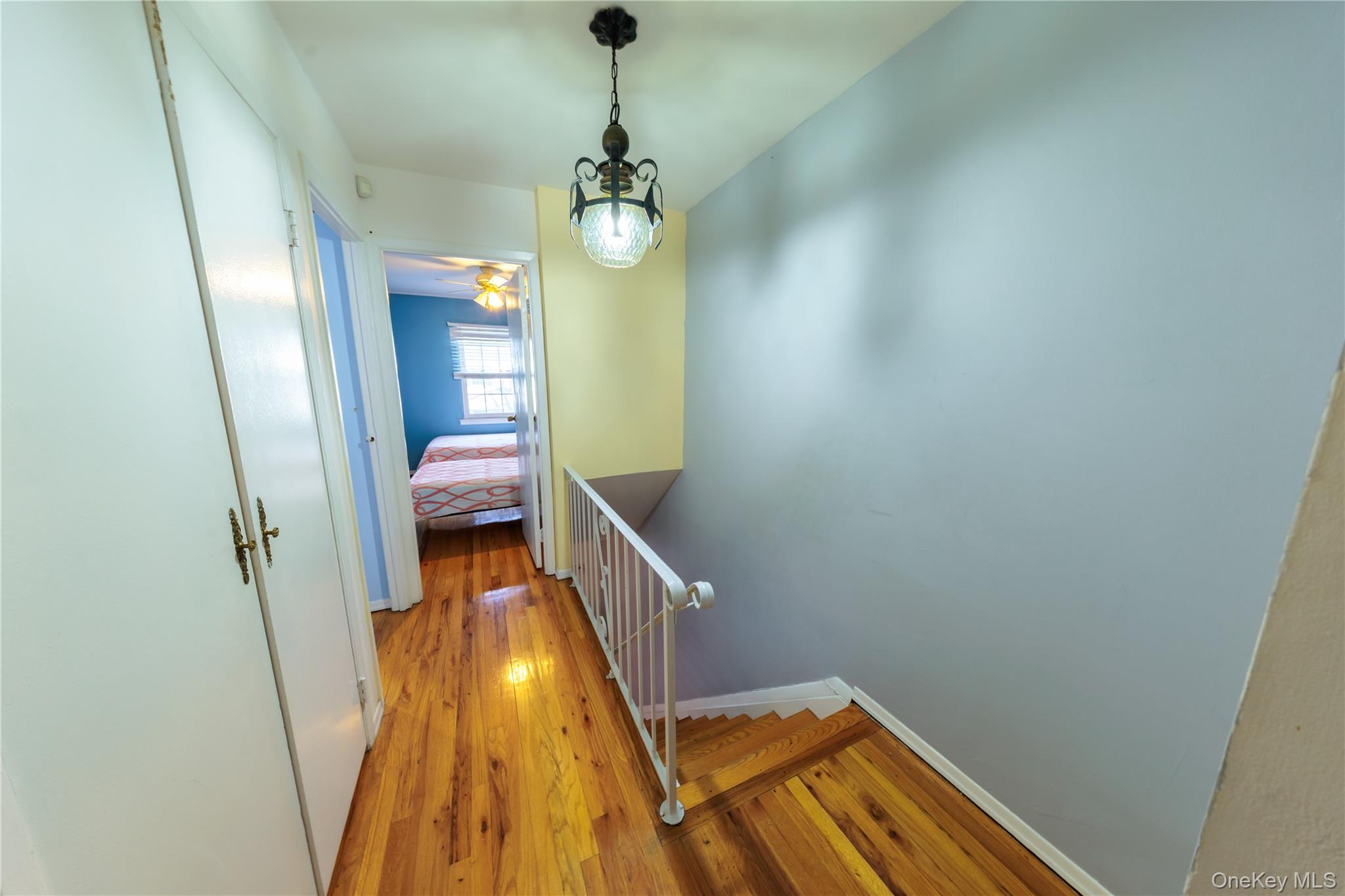 678 Front Street, Unit E Hempstead, NY 11550 - Photo 19 of 22 a view of a room with wooden floor and staircase