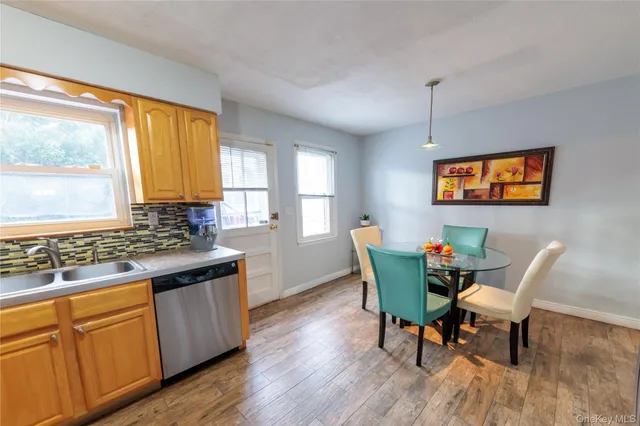 a living room with furniture dining table and large windows