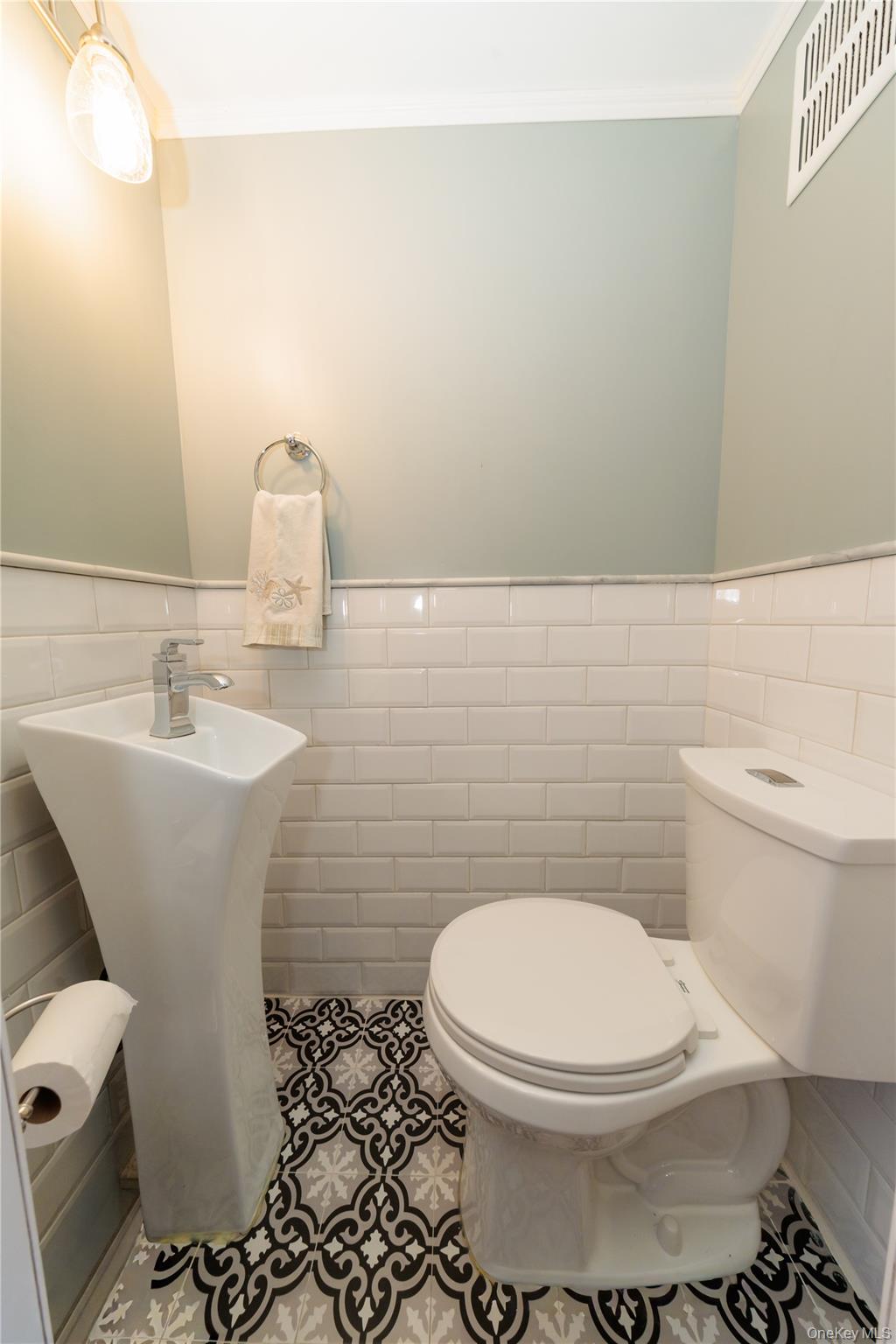 678 Front Street, Unit E Hempstead, NY 11550 - Photo 7 of 22 a bathroom with a toilet sink and mirror