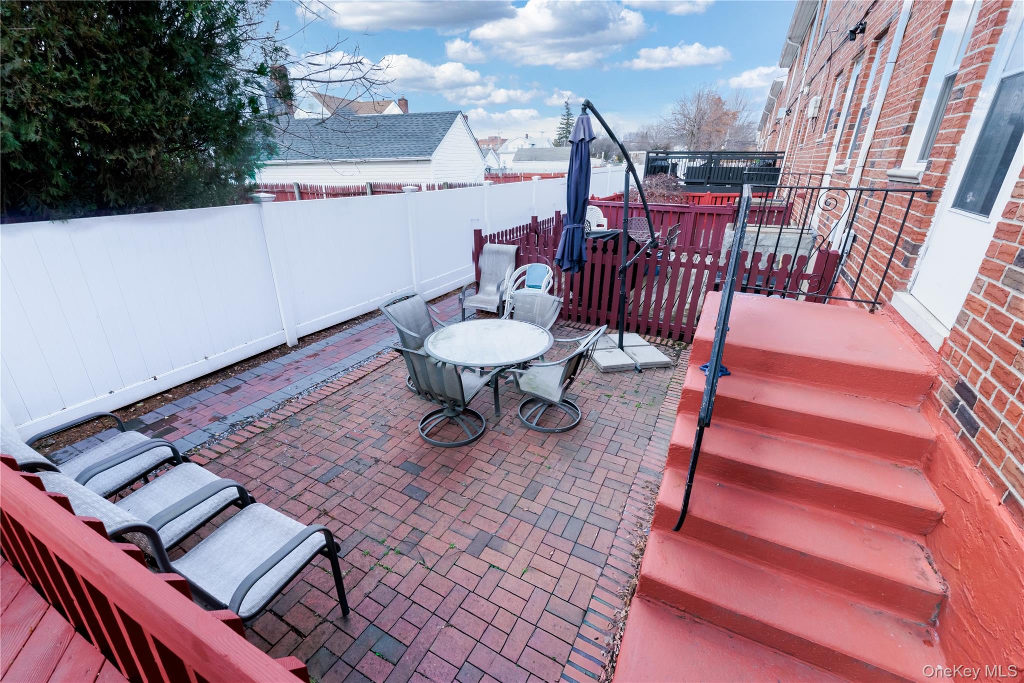 678 Front Street, Unit E Hempstead, NY 11550 - Photo 9 of 22 Fenced backyard with a patio area