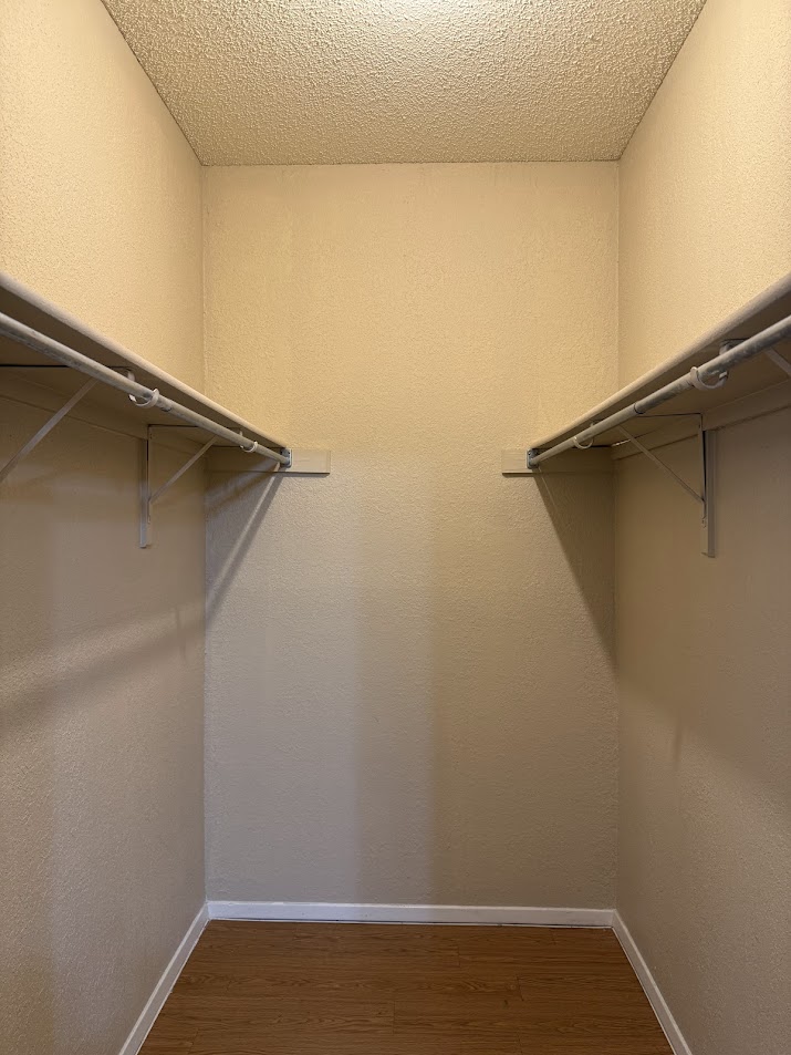 806 West 24th Street, Unit 223 Austin, TX 78705 - Photo 14 of 16 Walk in closet featuring wood finished floors
