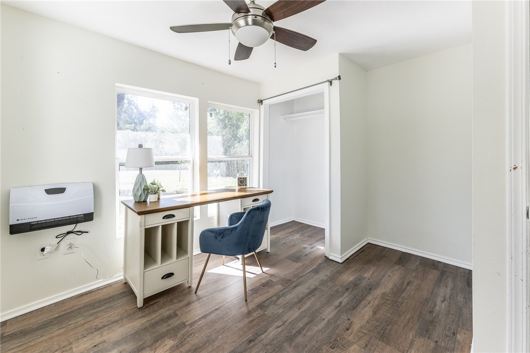1117 East Sycamore Street Navasota, TX 77868 - Photo 11 of 24 a view of a workspace with furniture and a window