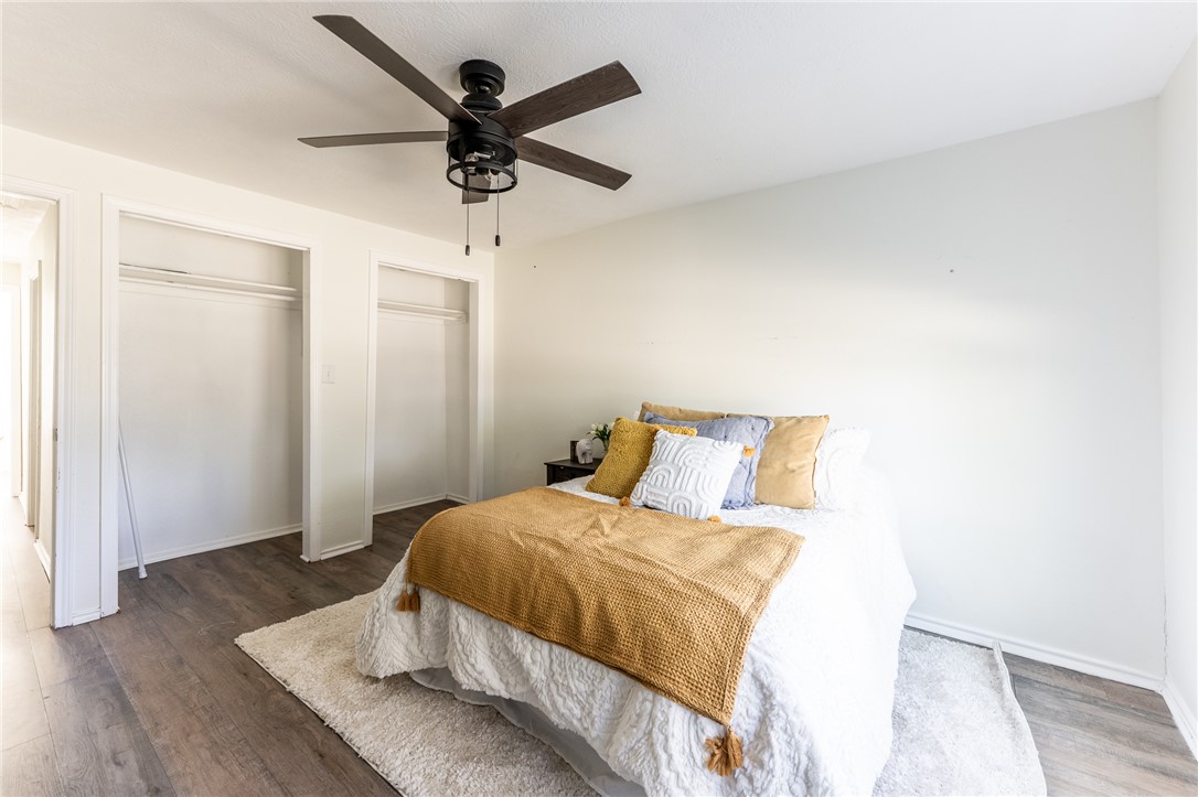 1117 East Sycamore Street Navasota, TX 77868 - Photo 16 of 24 a bedroom with a bed and wooden floor