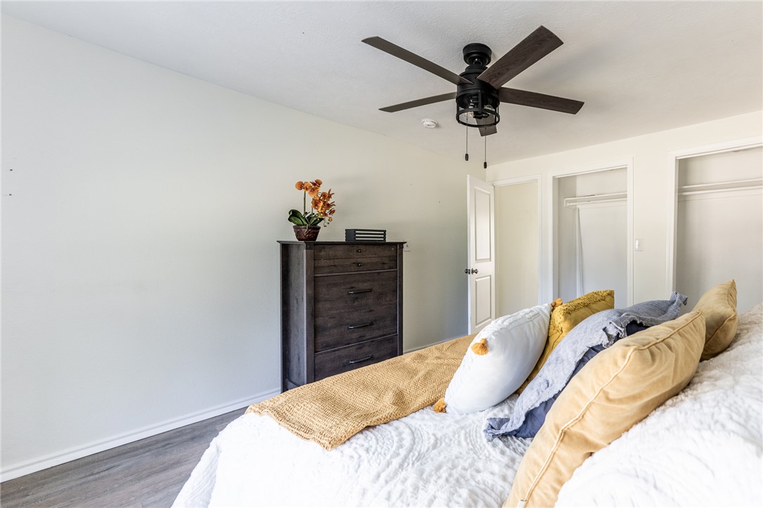 1117 East Sycamore Street Navasota, TX 77868 - Photo 17 of 24 a bed room with a bed and a ceiling fan