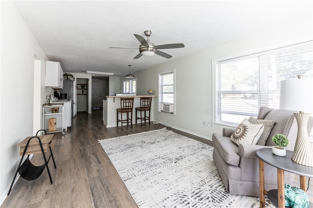 1117 East Sycamore Street Navasota, TX 77868 - Photo 2 of 24 a living room with furniture and wooden floor