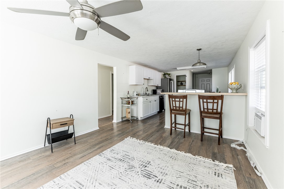 1117 East Sycamore Street Navasota, TX 77868 - Photo 3 of 24 a living room with stainless steel appliances kitchen island furniture and a kitchen view