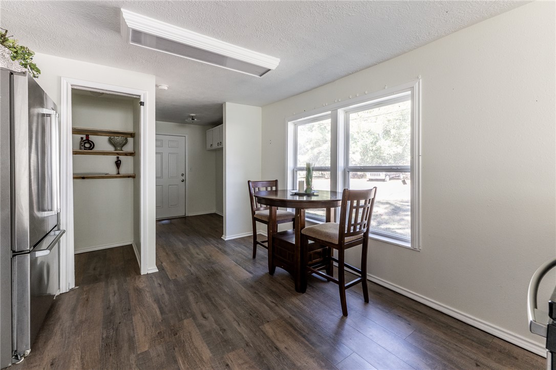 1117 East Sycamore Street Navasota, TX 77868 - Photo 7 of 24 a view of a dining room with furniture window and wooden floor