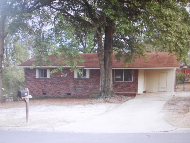 a front view of a house with yard and trees
