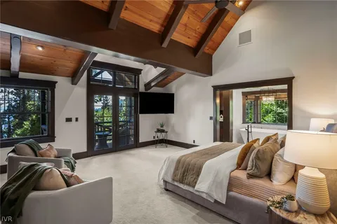 a bedroom with furniture and large windows