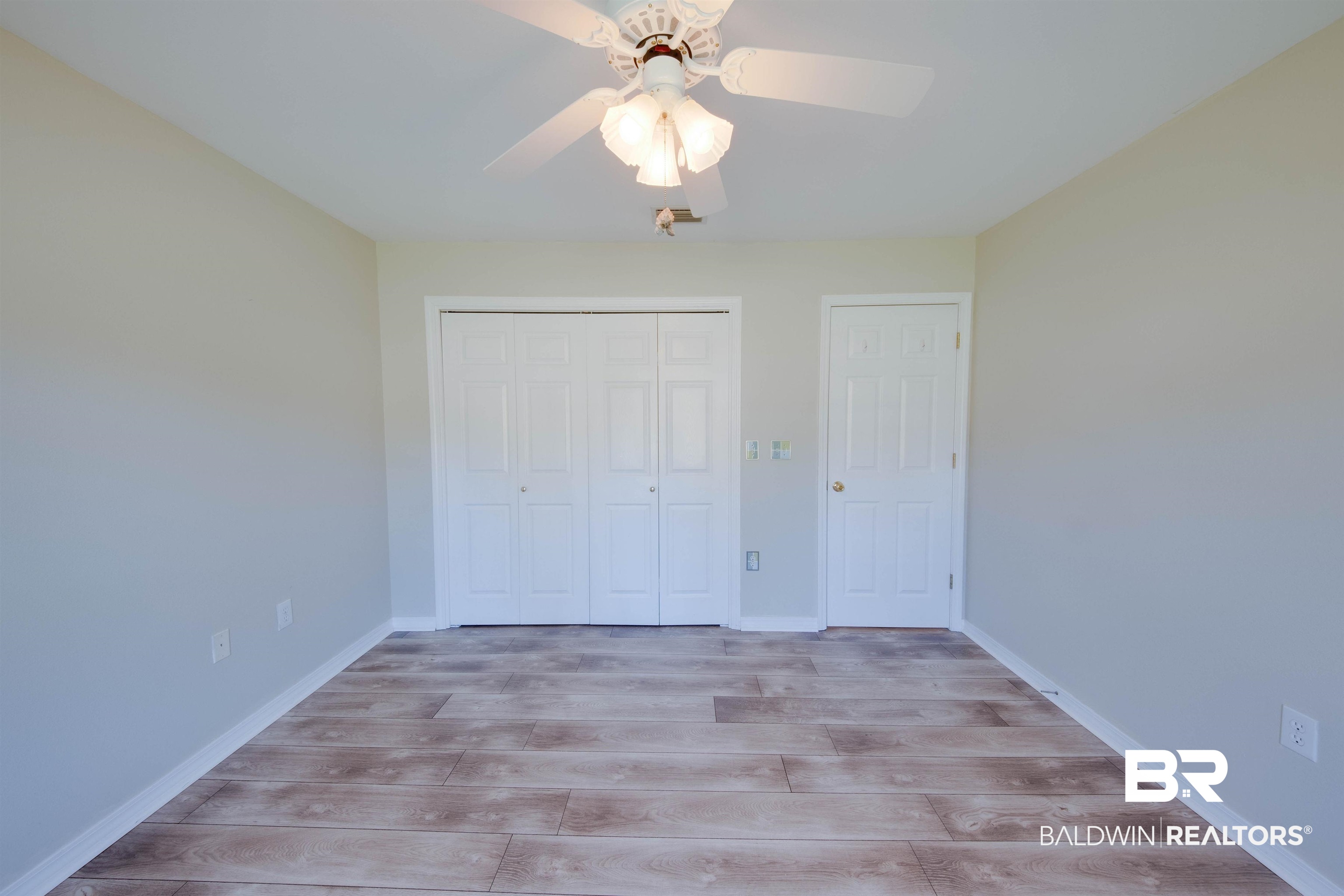 9462 Lakeview Drive Foley, AL 36535 - Photo 41 of 50 Unfurnished bedroom featuring a closet, light wood-type flooring, and ceiling fan