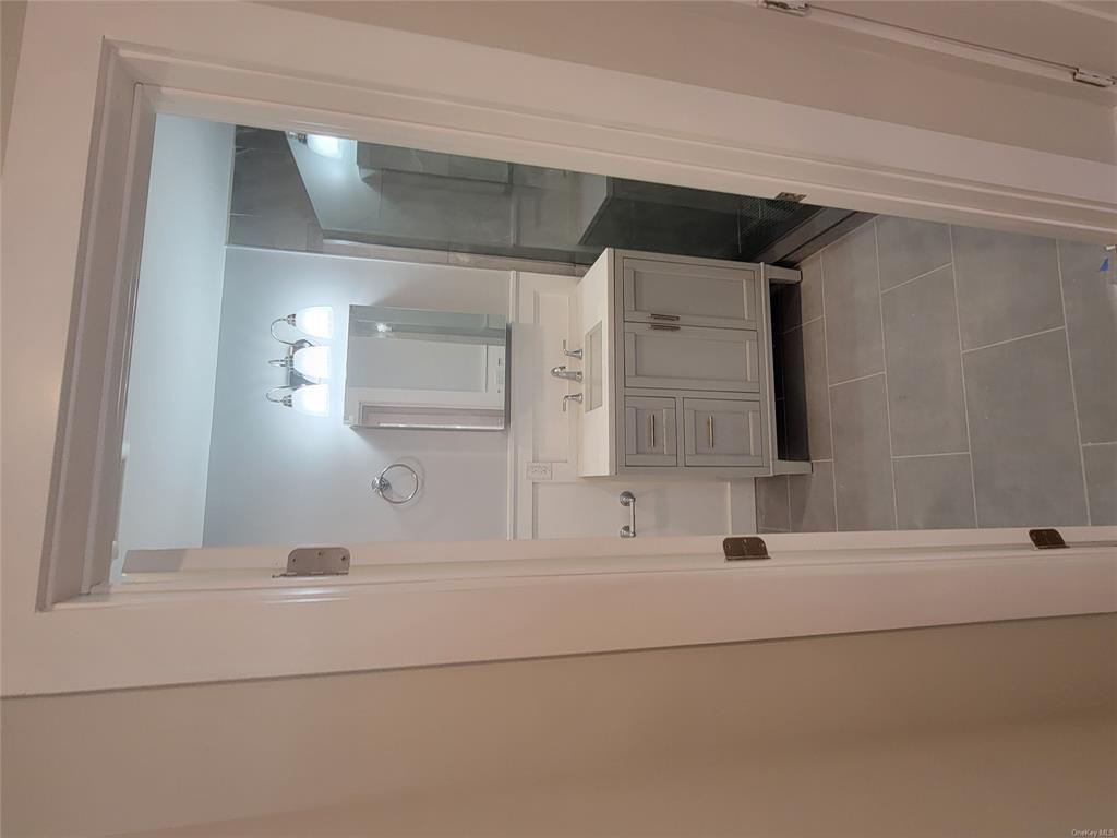731 Broadway, Unit 3 Valhalla, NY 10595 - Photo 11 of 14 Bathroom featuring vanity, tile patterned floors, and walk in shower