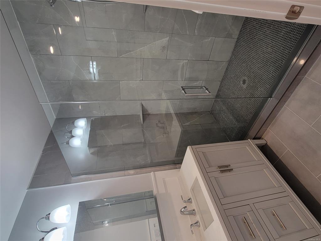 731 Broadway, Unit 3 Valhalla, NY 10595 - Photo 12 of 14 Bathroom featuring vanity, tile patterned floors, and an enclosed shower