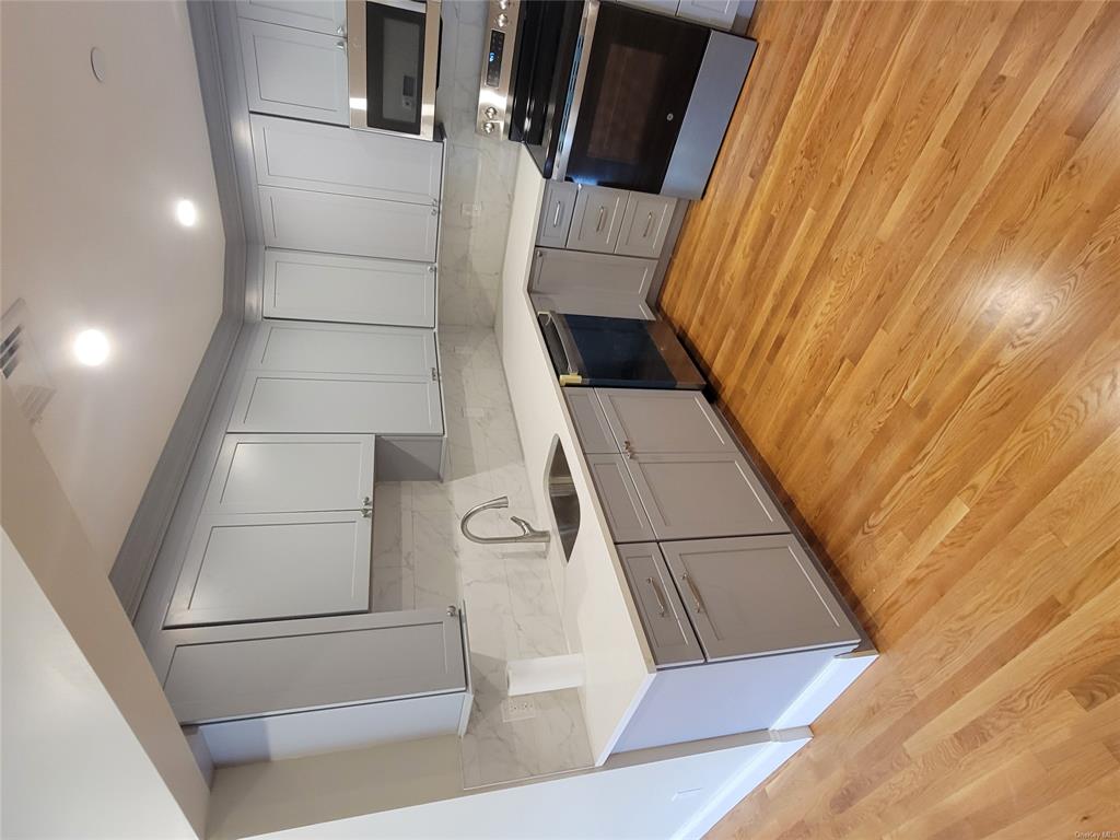 731 Broadway, Unit 3 Valhalla, NY 10595 - Photo 5 of 14 Kitchen with dishwashing machine, gray cabinets, stove, and sink