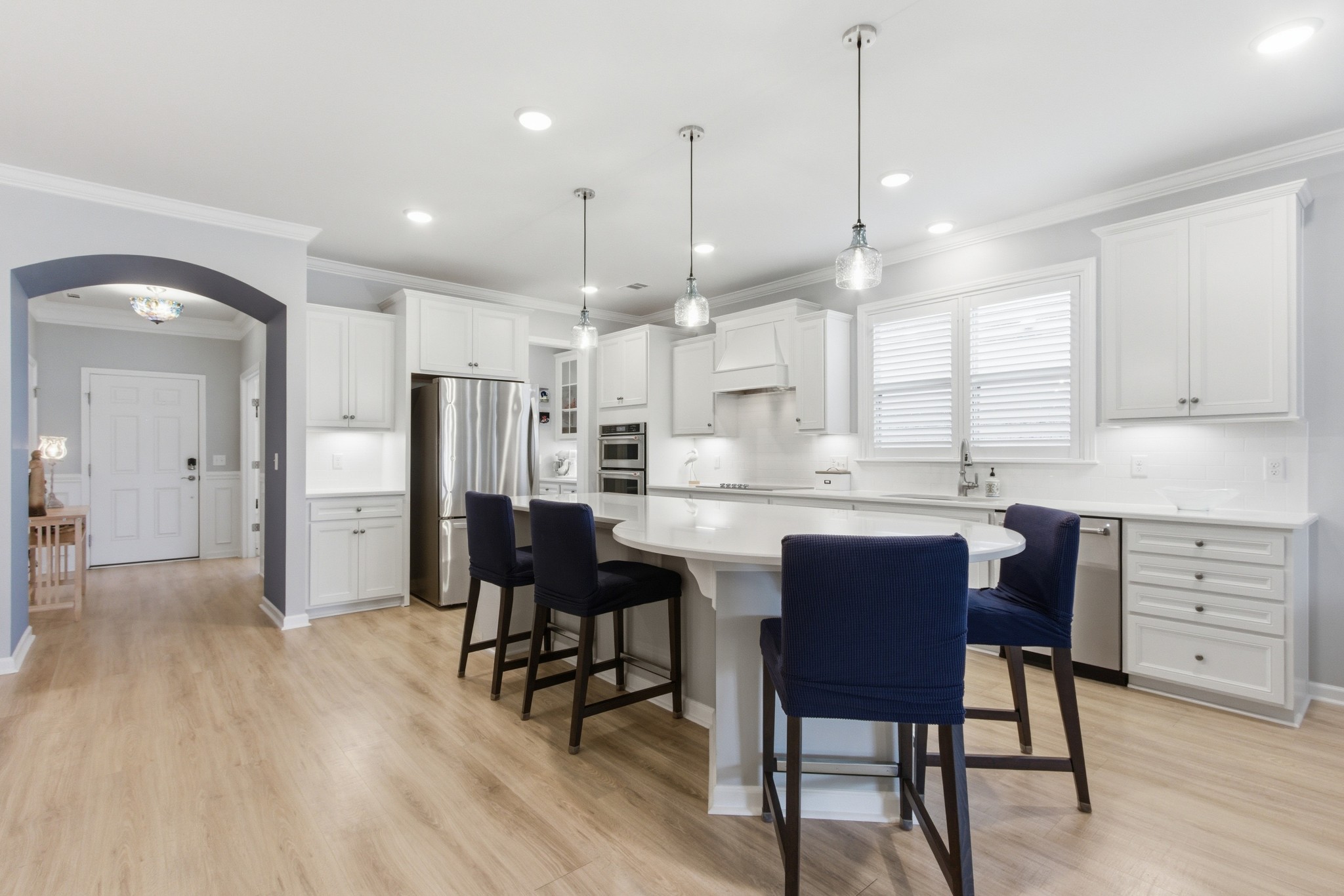 2321 Lawrence Ridge Spring Hill, TN 37174 - Photo 12 of 59 a kitchen with a dining table chairs wooden floor cabinets and stainless steel appliances