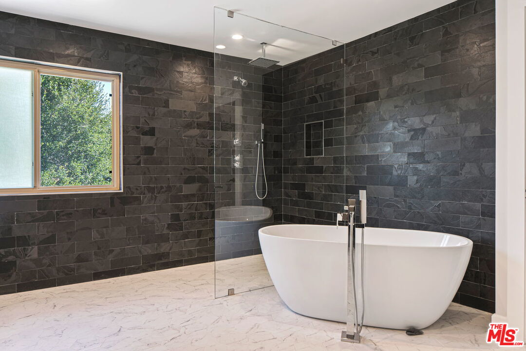 2526 Cordelia Road Los Angeles, CA 90049 - Photo 18 of 35 a white bath tub sitting in a bathroom