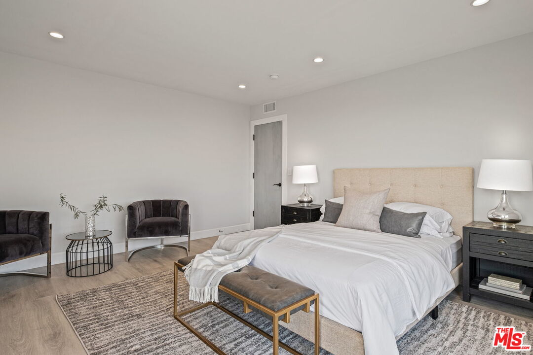 2526 Cordelia Road Los Angeles, CA 90049 - Photo 21 of 35 a bedroom with a bed and wooden floor