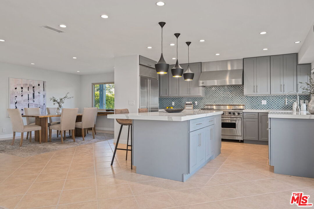 2526 Cordelia Road Los Angeles, CA 90049 - Photo 22 of 35 a kitchen with a sink counter top oven and cabinets