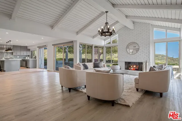 a living room with furniture wooden floor and a fireplace