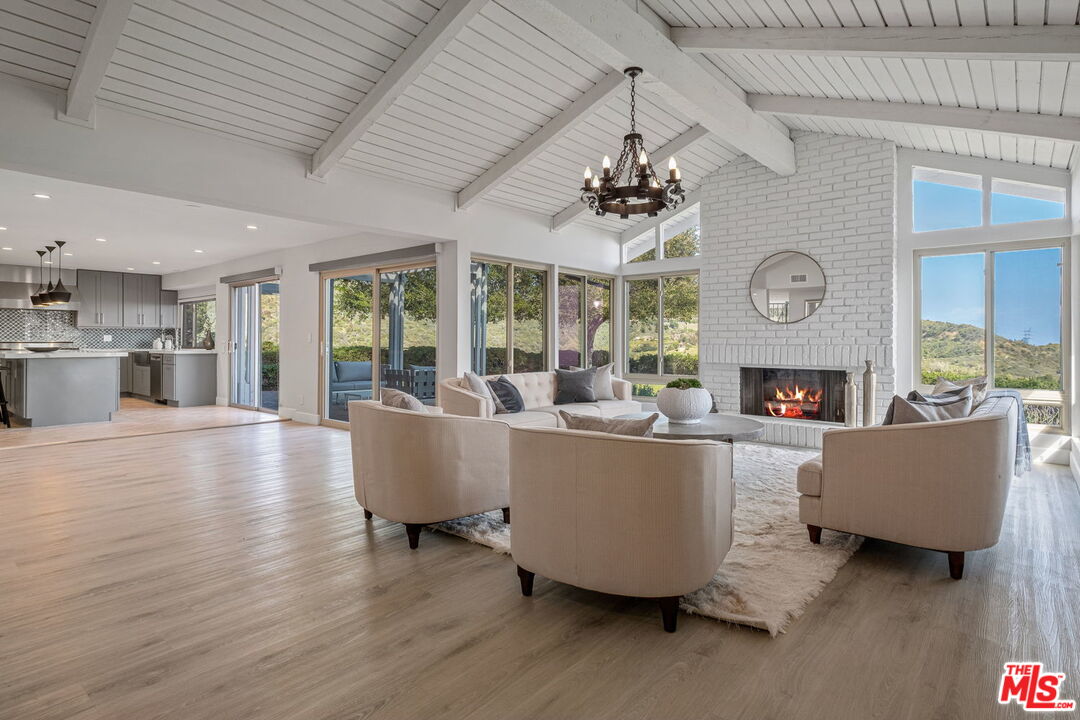 2526 Cordelia Road Los Angeles, CA 90049 - Photo 3 of 35 a living room with furniture wooden floor and a fireplace