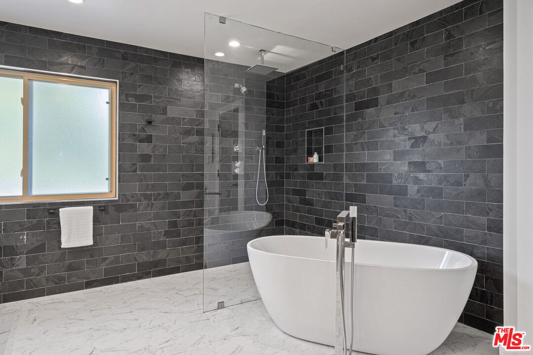 2526 Cordelia Road Los Angeles, CA 90049 - Photo 31 of 35 a bathroom with a bathtub and shower