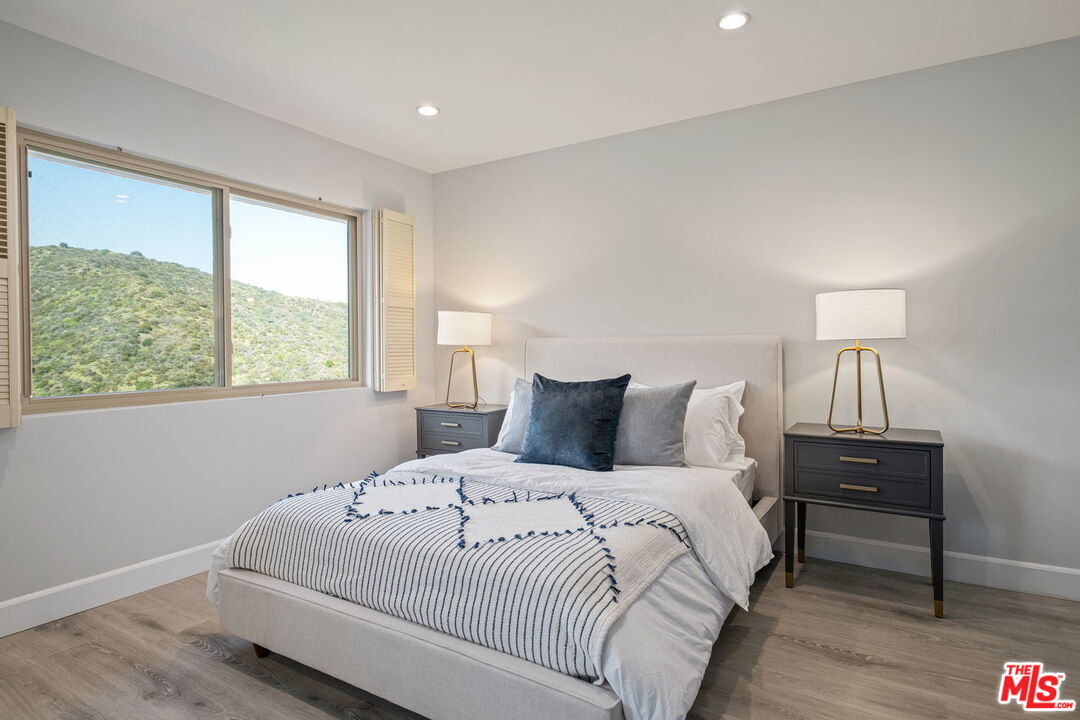 2526 Cordelia Road Los Angeles, CA 90049 - Photo 32 of 35 a large white bed in a bedroom next to a window