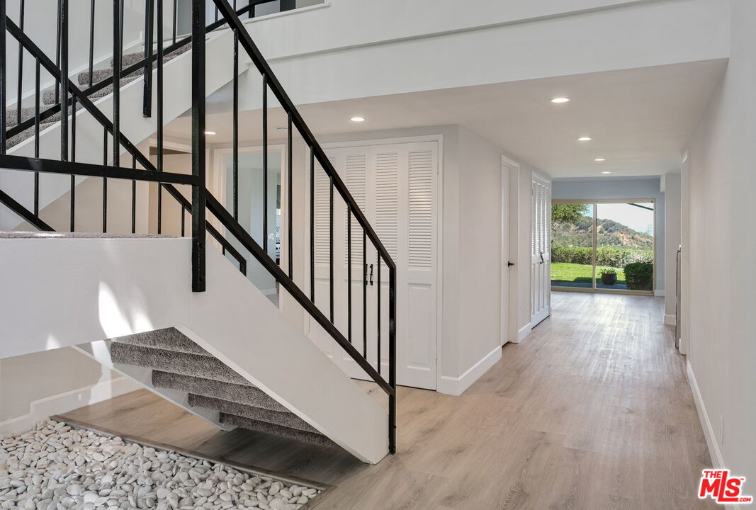 2526 Cordelia Road Los Angeles, CA 90049 - Photo 33 of 35 a view of entryway and hall with wooden floor