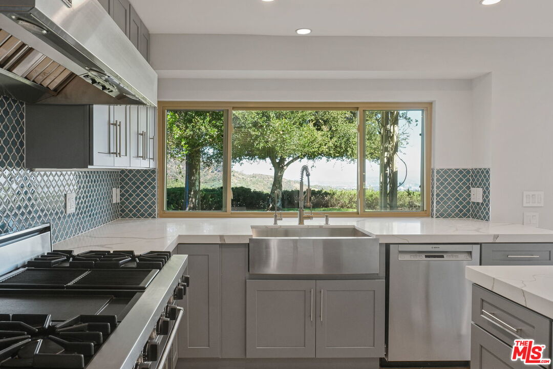 2526 Cordelia Road Los Angeles, CA 90049 - Photo 5 of 35 a kitchen with a sink stove and cabinets