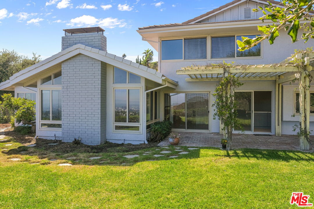 2526 Cordelia Road Los Angeles, CA 90049 - Photo 9 of 35 a view of a white house with a swimming pool