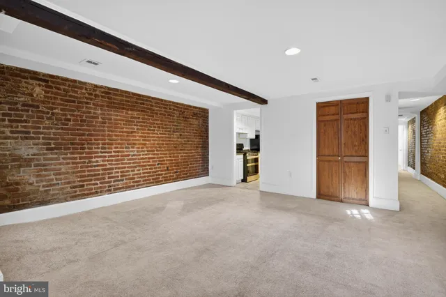a view of an empty room with closet and natural light