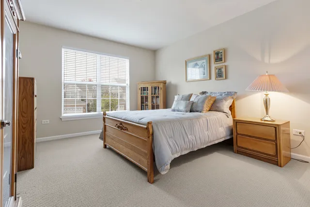 a spacious bedroom with a bed and a window