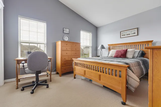 a bedroom with a bed and chair