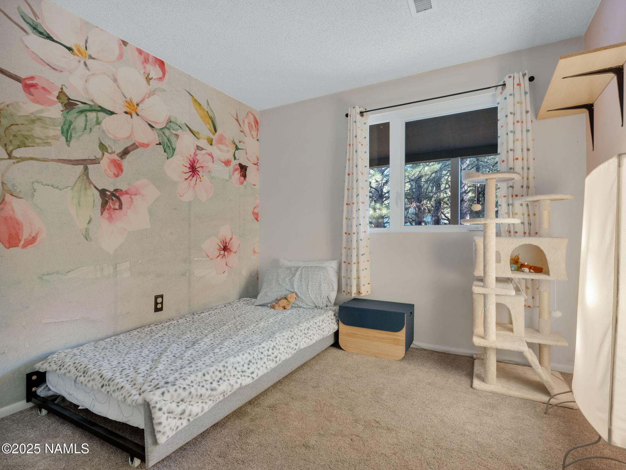 4449 Canyon Loop Flagstaff, AZ 86005 - Photo 13 of 37 a bedroom with a bed and a flat screen tv