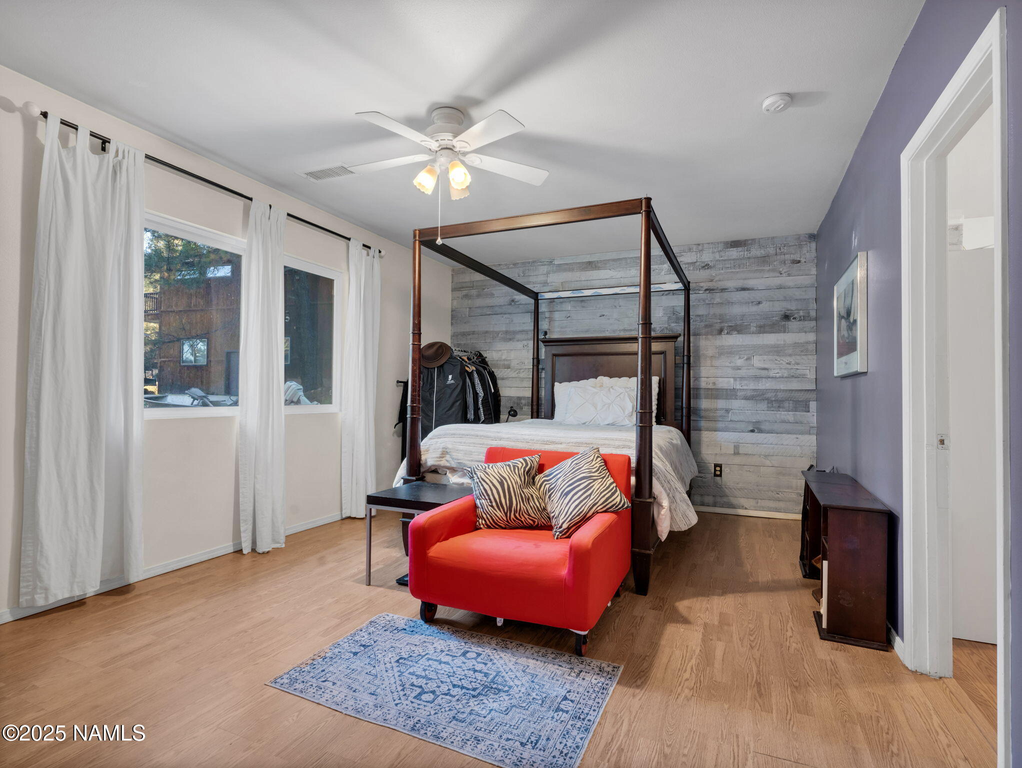 4449 Canyon Loop Flagstaff, AZ 86005 - Photo 14 of 37 a bedroom with a bed and wooden floor