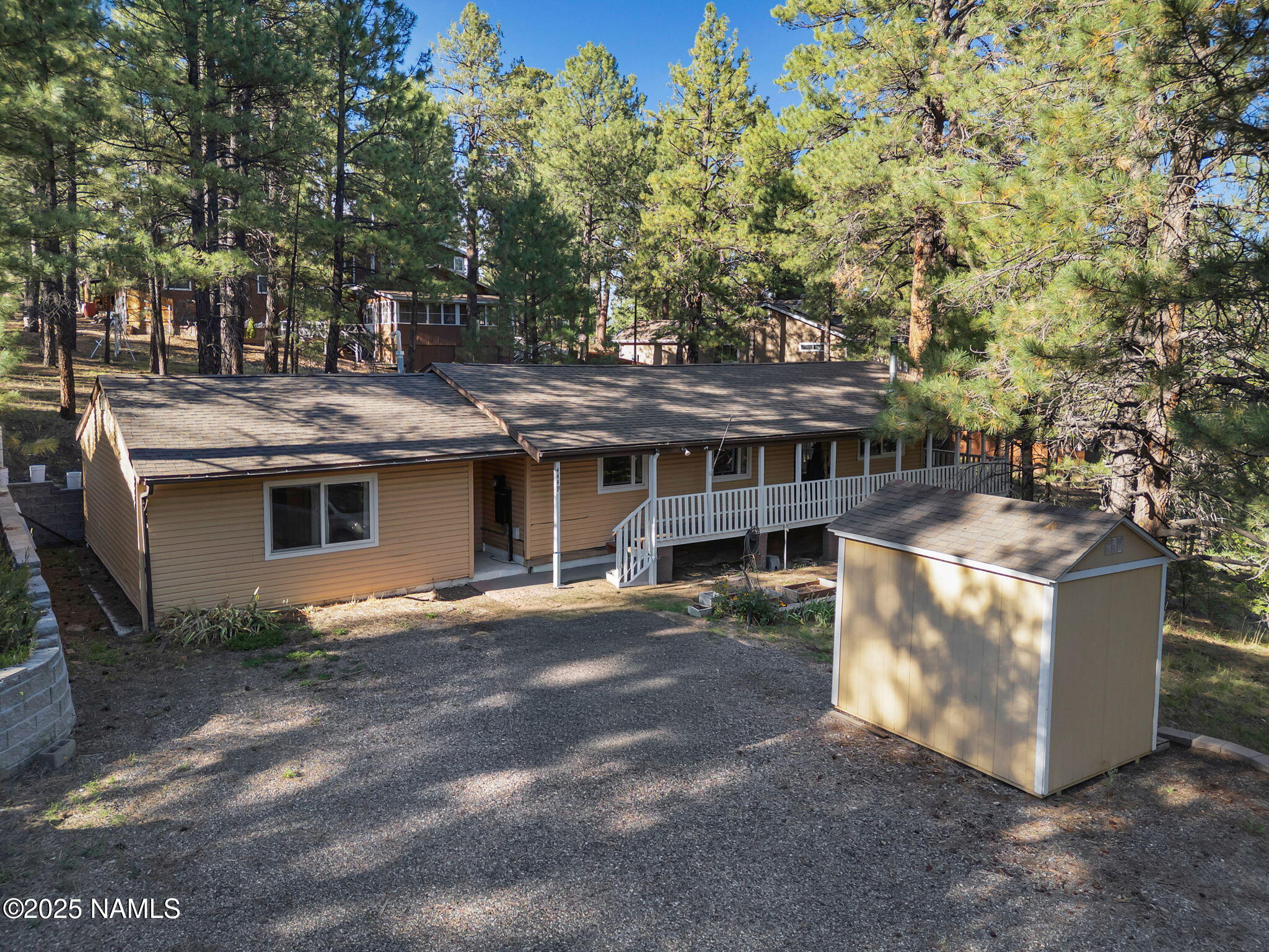 4449 Canyon Loop Flagstaff, AZ 86005 - Photo 27 of 37 a view of a house with a yard and sitting area