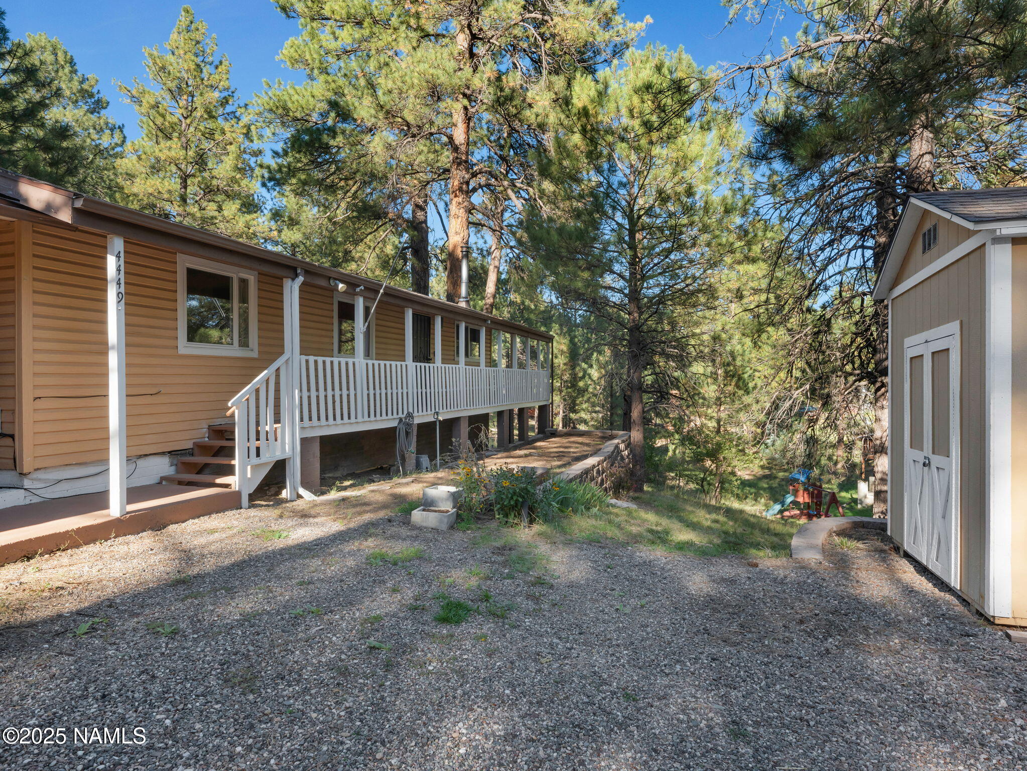 4449 Canyon Loop Flagstaff, AZ 86005 - Photo 32 of 37 a view of a house with a yard