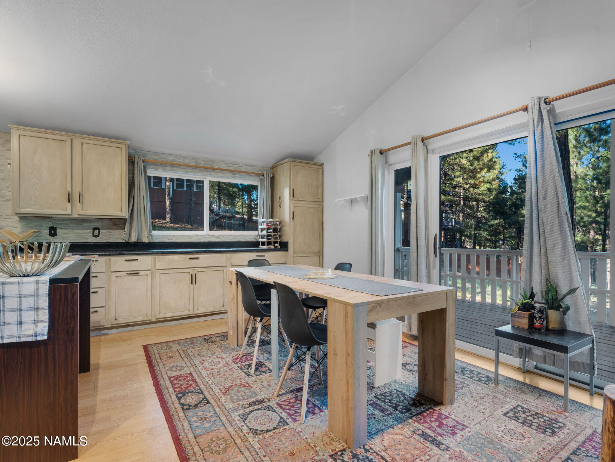 4449 Canyon Loop Flagstaff, AZ 86005 - Photo 6 of 37 a open kitchen with a stove a sink dishwasher and a dining table with wooden floor