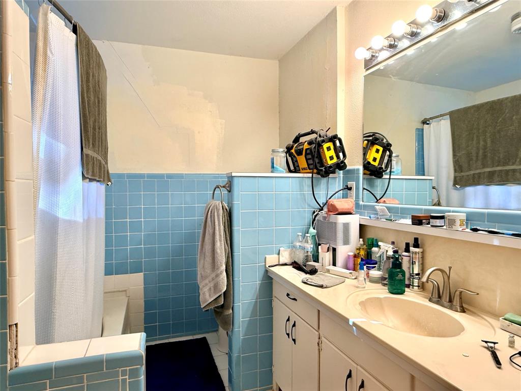 429 Agnes Avenue Marlin, TX 76661 - Photo 18 of 28 a bathroom with a sink mirror and a shower