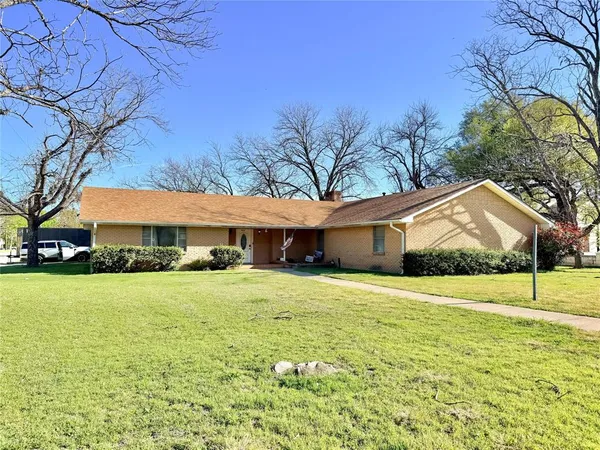 a house that has a tree in front of it