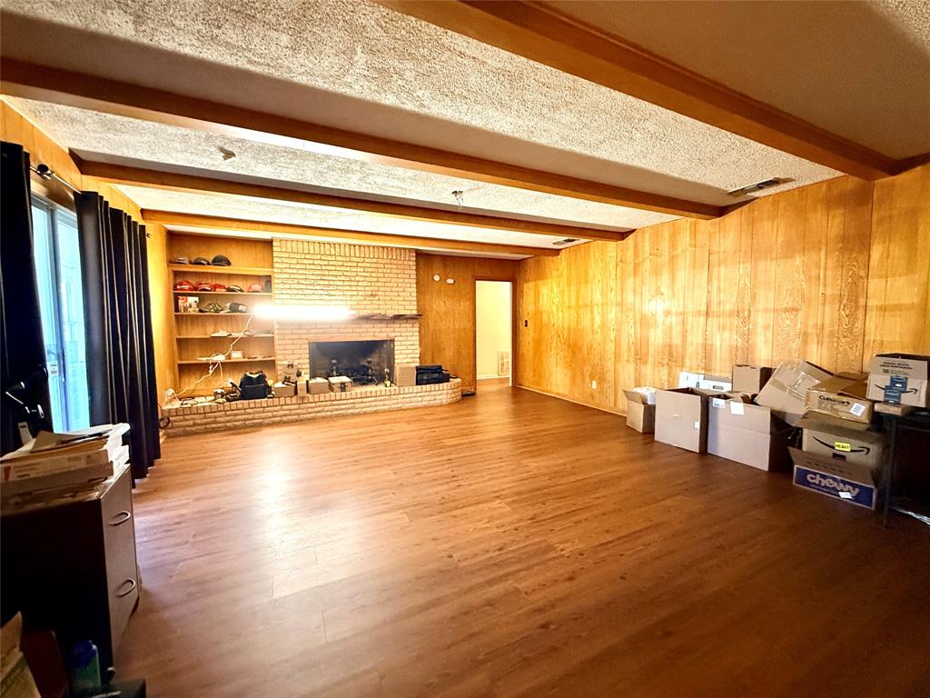429 Agnes Avenue Marlin, TX 76661 - Photo 10 of 28 a view of an empty room with wooden floor and a floor to ceiling window