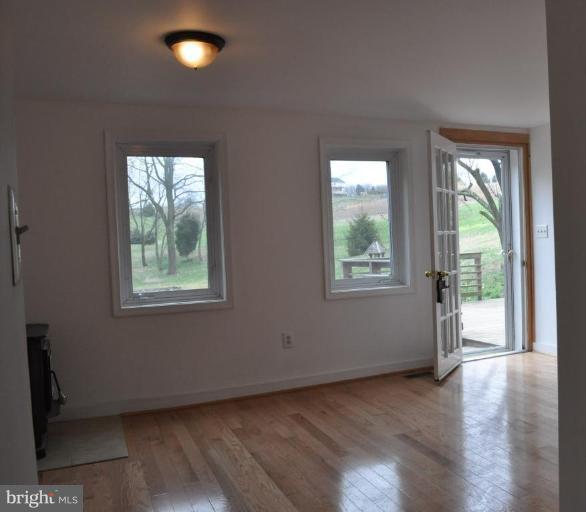 5300 Wertz Road Hampstead, MD 21074 - Photo 9 of 25 an empty room with wooden floor and windows