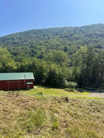 a view of a balcony with furniture and wooden floor